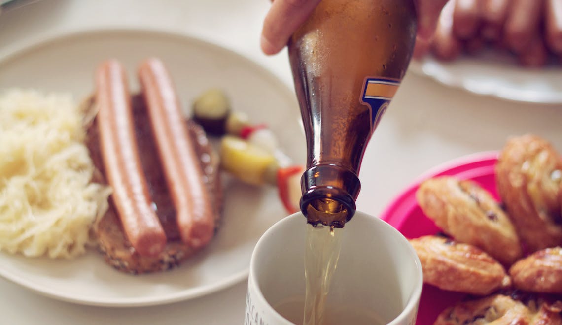 Enjoy a classic German meal with sausages, beer, and pastries in a cozy setting.