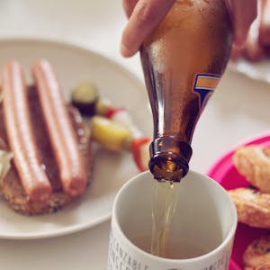 Enjoy a classic German meal with sausages, beer, and pastries in a cozy setting.