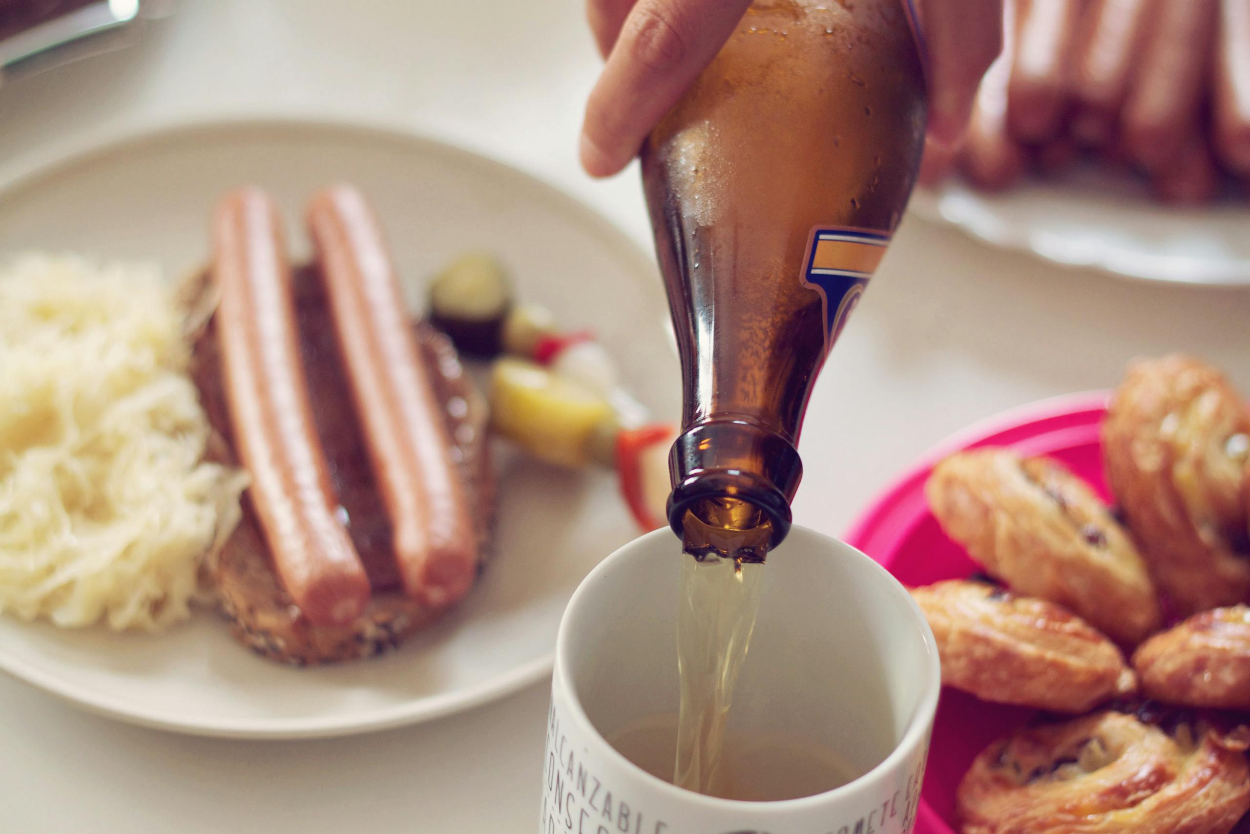 Enjoy a classic German meal with sausages, beer, and pastries in a cozy setting.